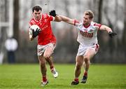 4 February 2024; Craig Lennon of Louth in action against Ruairi Deane of Cork during the Allianz Football League Division 2 match between Louth and Cork at DEFY Páirc Mhuire in Ardee, Louth. Photo by Ben McShane/Sportsfile