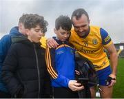 4 February 2024; Donnie Smith of Roscommon gets a picture with Roscommon supporter Cian Gallagher, aged 11, from St Brigid's GAA Club, after the Allianz Football League Division 1 match between Roscommon and Galway at Dr Hyde Park in Roscommon. Photo by Daire Brennan/Sportsfile