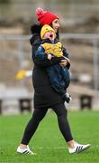 4 February 2024; Rory Daly, aged 1, son of Roscommon player Niall Daly, with his mother Martha, after the Allianz Football League Division 1 match between Roscommon and Galway at Dr Hyde Park in Roscommon. Photo by Daire Brennan/Sportsfile
