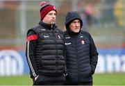 4 February 2024; Derry coach Gavin Devlin, left, and Derry manager Mickey Harte before the Allianz Football League Division 1 match between Derry and Tyrone at Celtic Park in Derry. Photo by Ramsey Cardy/Sportsfile