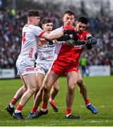 4 February 2024; Christopher McKaigue of Derry is tackled by Aidan Clarke, left, Niall Devlin, centre, and Brian Kennedy of Tyrone during the Allianz Football League Division 1 match between Derry and Tyrone at Celtic Park in Derry. Photo by Ramsey Cardy/Sportsfile
