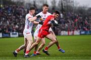 4 February 2024; Christopher McKaigue of Derry is tackled by Aidan Clarke, left, and Brian Kennedy of Tyrone during the Allianz Football League Division 1 match between Derry and Tyrone at Celtic Park in Derry. Photo by Ramsey Cardy/Sportsfile