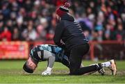 4 February 2024; Derry goalkeeper Odhran Lynch is treated for an injury before being substituted during the Allianz Football League Division 1 match between Derry and Tyrone at Celtic Park in Derry. Photo by Ramsey Cardy/Sportsfile