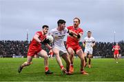 4 February 2024; Ciarán Daly of Tyrone in action against Padraig McGrogan, left, and Conor Glass of Derry during the Allianz Football League Division 1 match between Derry and Tyrone at Celtic Park in Derry. Photo by Ramsey Cardy/Sportsfile
