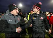 4 February 2024; Derry manager Mickey Harte, left, and Tyrone joint-manager Brian Dooher shake hands after the Allianz Football League Division 1 match between Derry and Tyrone at Celtic Park in Derry. Photo by Ramsey Cardy/Sportsfile