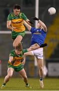 4 February 2024; Ryan Brady of Cavan in action against Michael Langan, top, and Oisín Caulfield of Donegal during the Allianz Football League Division 2 match between Cavan and Donegal at Kingspan Breffni in Cavan. Photo by Stephen McCarthy/Sportsfile