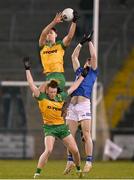 4 February 2024; Donegal's Michael Langan claims possession ahead of team-mate Oisín Caulfield and Ryan Brady of Cavan during the Allianz Football League Division 2 match between Cavan and Donegal at Kingspan Breffni in Cavan. Photo by Stephen McCarthy/Sportsfile