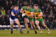 4 February 2024; Caolan McGonagle with the support of his Donegal team-mate Odhran Doherty, right, in action against Niall Carolan of Cavan during the Allianz Football League Division 2 match between Cavan and Donegal at Kingspan Breffni in Cavan. Photo by Stephen McCarthy/Sportsfile