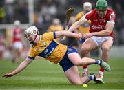 4 February 2024; Adam Hogan of Clare is tackled by Robbie O'Flynn of Cork during the Allianz Hurling League Division 1 Group A match between Clare and Cork at Cusack Park in Ennis, Clare. Photo by Ray McManus/Sportsfile