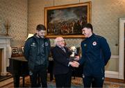 6 February 2024; The President of Ireland Michael D Higgins receives FAI President's Cup representatives Lee Grace of Shamrock Rovers, left, and Joe Redmond of St Patrick's Athletic at Áras an Uachtaráin in Dublin. On Friday 9th February, last season’s SSE Airtricity Men’s Premier Division champions Shamrock Rovers will play the 2023 Sports Direct Men’s FAI Cup winners St Patrick’s Athletic. On Saturday 2 March, 2023 Sports Direct FAI Women's Cup winners Athlone Town will play the SSE Airtricity Women's Premier Division champions Peamount United at Athlone Town Stadium. Photo by Stephen McCarthy/Sportsfile
