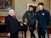 6 February 2024; The President of Ireland Michael D Higgins receives FAI President's Cup representatives Lee Grace of Shamrock Rovers and Joe Redmond of St Patrick's Athletic, right, at Áras an Uachtaráin in Dublin. On Friday 9th February, last season’s SSE Airtricity Men’s Premier Division champions Shamrock Rovers will play the 2023 Sports Direct Men’s FAI Cup winners St Patrick’s Athletic. On Saturday 2 March, 2023 Sports Direct FAI Women's Cup winners Athlone Town will play the SSE Airtricity Women's Premier Division champions Peamount United at Athlone Town Stadium. Photo by Stephen McCarthy/Sportsfile