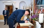 6 February 2024; Joe Redmond of St Patrick's Athletic signs the guest book on arrival for The President of Ireland Michael D Higgins to receive FAI President's Cup representatives at Áras an Uachtaráin in Dublin. On Friday 9th February, last season’s SSE Airtricity Men’s Premier Division champions Shamrock Rovers will play the 2023 Sports Direct Men’s FAI Cup winners St Patrick’s Athletic. On Saturday 2 March, 2023 Sports Direct FAI Women's Cup winners Athlone Town will play the SSE Airtricity Women's Premier Division champions Peamount United at Athlone Town Stadium. Photo by Stephen McCarthy/Sportsfile