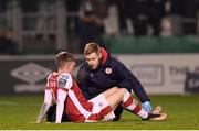 9 February 2024; Chris Forrester of St Patrick's Athletic receives treatment from St Patrick's Athletic head of medical Sam Rice during the 2024 Men's President's Cup match between Shamrock Rovers and St Patrick's Athletic at Tallaght Stadium in Dublin. Photo by Stephen McCarthy/Sportsfile