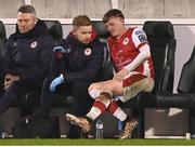 9 February 2024; Chris Forrester of St Patrick's Athletic with St Patrick's Athletic head of medical Sam Rice on the bench during the 2024 Men's President's Cup match between Shamrock Rovers and St Patrick's Athletic at Tallaght Stadium in Dublin. Photo by Stephen McCarthy/Sportsfile