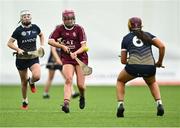 10 February 2024; Kate Connolly of Marino passes under pressure from Ellen Shields of UUM, 6, during the Electric Ireland Ashling Murphy Cup final match between Ulster University Magee and Marino at University of Galway Connacht GAA Centre of Excellence in Bekan, Mayo. Photo by Piaras Ó Mídheach/Sportsfile