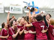 10 February 2024; Marino captain Kate McClusky holds the cup aloft as she celebrates with team-mates after their victory in the Electric Ireland Ashling Murphy Cup final match between Ulster University Magee and Marino at University of Galway Connacht GAA Centre of Excellence in Bekan, Mayo. Photo by Piaras Ó Mídheach/Sportsfile
