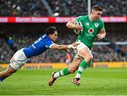 11 February 2024; Jack Crowley of Ireland on his way to scoring his side's first try despite the efforts of Ange Capuozzo of Italy during the Guinness Six Nations Rugby Championship match between Ireland and Italy at the Aviva Stadium in Dublin. Photo by Brendan Moran/Sportsfile