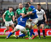 11 February 2024; Caelan Doris of Ireland is tackled by Michele Lamaro, left, and Federico Ruzza of Italy during the Guinness Six Nations Rugby Championship match between Ireland and Italy at the Aviva Stadium in Dublin. Photo by Brendan Moran/Sportsfile