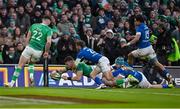 11 February 2024; Calvin Nash of Ireland dives over to score his side's sixth try despite the efforts of Martin Page-Relo of Italy during the Guinness Six Nations Rugby Championship match between Ireland and Italy at the Aviva Stadium in Dublin. Photo by Brendan Moran/Sportsfile
