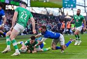 11 February 2024; Calvin Nash of Ireland dives over to score his side's sixth try despite the efforts of Martin Page-Relo of Italy during the Guinness Six Nations Rugby Championship match between Ireland and Italy at the Aviva Stadium in Dublin. Photo by Piaras Ó Mídheach/Sportsfile