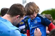 12 February 2024; Leinster supporter Theo Maybury, aged four, from Mullingar, Westemath, has his jersey signed by John McKee during a training session on the Leinster Rugby 12 County Tour at Mullingar RFC in Westmeath. Photo by Harry Murphy/Sportsfile