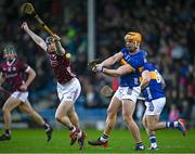 11 February 2024; Ronan Maher of Tipperary clears under pressure from John Cooney of Galway during the Allianz Hurling League Division 1 Group B match between Tipperary and Galway at FBD Semple Stadium in Thurles, Tipperary. Photo by Ray McManus/Sportsfile