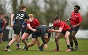 14 February 2024; Jack Power of Metro is tackled by Liam Riley, left, and Jack Giles of North East during the BearingPoint Shane Horgan Cup Round 4 match between Metro and North East at Ashbourne RFC in Meath. Photo by Ben McShane/Sportsfile