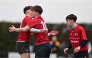 14 February 2024; Lorcan Craik of North East, centre, celebrates with teammates David Soden, left, and Finn O'Reilly after scoring a try during the BearingPoint Shane Horgan Cup Round 4 match between Metro and North East at Ashbourne RFC in Meath. Photo by Ben McShane/Sportsfile