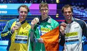 14 February 2024; Daniel Wiffen of Ireland, centre, who won gold, with Elijah Winnington of Australia, who won silver, and Gregorio Paltrinieri of Italy, who won bronze, after the Men's 800m freestyle final during day four of the World Aquatics Championships 2024 at the Aspire Dome in Doha, Qatar. Photo by Ian MacNicol/Sportsfile