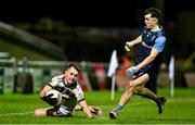 14 February 2024; Darragh Canavan of Ulster University in action against Darragh McElearney of UCD during the Electric Ireland Higher Education GAA Sigerson Cup final match between UCD and Ulster University at Austin Stack Park in Tralee, Kerry. Photo by Brendan Moran/Sportsfile