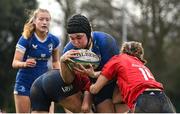 15 February 2024; Lily Byrne of Leinster is tackled by Munster players Aoife Grimes, left, and Niamh Crotty on her way to scoring her side's second try during the U18 Girls Interprovincial semi-final match between Leinster and Munster at Terenure College RFC in Dublin. Photo by Seb Daly/Sportsfile