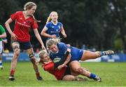 15 February 2024; Kate Noons of Leinster is tackled by Mia Hennelly of Munster during the U18 Girls Interprovincial semi-final match between Leinster and Munster at Terenure College RFC in Dublin. Photo by Seb Daly/Sportsfile