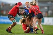 15 February 2024; Clara Dunne of Leinster is tackled by Munster players, from left, Ava O’Malley, Lyndsay Clarke and Mia Hennelly during the U18 Girls Interprovincial semi-final match between Leinster and Munster at Terenure College RFC in Dublin. Photo by Seb Daly/Sportsfile