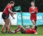 15 February 2024; Meghan Crilly of Munster, bottom, celebrates after scoring her side's first try during the U18 Girls Interprovincial semi-final match between Leinster and Munster at Terenure College RFC in Dublin. Photo by Shauna Clinton/Sportsfile