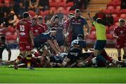16 February 2024; Ruadhan Quinn of Munster is pushed over to score a try during the United Rugby Championship match between Scarlets and Munster at Parc y Scarlets in Llanelli, Wales. Photo by Chris Fairweather/Sportsfile