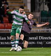 16 February 2024; Neil Farrugia of Shamrock Rovers in action against Zak Bradshaw of Dundalk during the SSE Airtricity Men's Premier Division match between Shamrock Rovers and Dundalk at Tallaght Stadium in Dublin. Photo by Ben McShane/Sportsfile