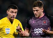 16 February 2024; Referee Rob Hennessy and Jamie Gullan of Dundalk during the SSE Airtricity Men's Premier Division match between Shamrock Rovers and Dundalk at Tallaght Stadium in Dublin. Photo by Stephen McCarthy/Sportsfile