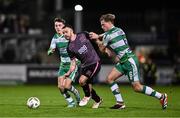 16 February 2024; Robbie Benson of Dundalk in action against Darragh Burns, left, and Daniel Cleary of Shamrock Rovers during the SSE Airtricity Men's Premier Division match between Shamrock Rovers and Dundalk at Tallaght Stadium in Dublin. Photo by Ben McShane/Sportsfile