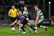 16 February 2024; Robbie Benson of Dundalk in action against Darragh Burns, left, and Daniel Cleary of Shamrock Rovers during the SSE Airtricity Men's Premier Division match between Shamrock Rovers and Dundalk at Tallaght Stadium in Dublin. Photo by Ben McShane/Sportsfile