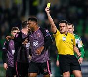 16 February 2024; Mayowa Animasahun of Dundalk is shown a yellow card by referee Rob Hennessy during the SSE Airtricity Men's Premier Division match between Shamrock Rovers and Dundalk at Tallaght Stadium in Dublin. Photo by Stephen McCarthy/Sportsfile