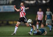 16 February 2024; Cameron McJannet of Derry City is tackled by Darragh Markey of Drogheda United  during the SSE Airtricity Men's Premier Division match between Derry City and Drogheda United at The Ryan McBride Brandywell Stadium in Derry. Photo by Ramsey Cardy/Sportsfile
