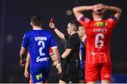 16 February 2024; Referee Kevin O'Sullivan shows a red card to Sean Boyd of Shelbourne, not pictured, during the SSE Airtricity Men's Premier Division match between Waterford and Shelbourne at the Regional Sports Centre in Waterford. Photo by Harry Murphy/Sportsfile