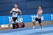 17 February 2024; Jack Raftery of Donore Harriers AC, Dublin, left, competing in the senior men's 400m during day one of the 123.ie National Senior Indoor Championships at the Sport Ireland National Indoor Arena in Dublin. Photo by Tyler Miller/Sportsfile