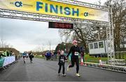 17 February 2024; Sarah Curry, right, and Robyn Forde cross the finish line during the Operation Transformation 5K at Phoenix Park in Dublin. Photo by David Fitzgerald/Sportsfile