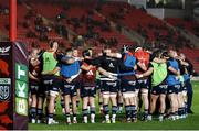 16 February 2024; The Munster team huddle before the United Rugby Championship match between Scarlets and Munster at Parc y Scarlets in Llanelli, Wales. Photo by Gruffydd Thomas/Sportsfile