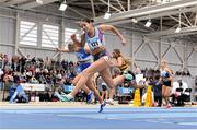 17 February 2024; Kate Doherty of Dundrum South Dublin AC, Dublin, crosses the finish line to win the women's 60m hurdles heats during day one of the 123.ie National Senior Indoor Championships at the Sport Ireland National Indoor Arena in Dublin. Photo by Tyler Miller/Sportsfile