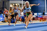 17 February 2024; Sarah Lavin of Emerald AC, Limerick, crosses the finish line to win the senior women's 60m hurdles finals during day one of the 123.ie National Senior Indoor Championships at the Sport Ireland National Indoor Arena in Dublin. Photo by Tyler Miller/Sportsfile