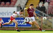 18 February 2024; Robert Finnerty of Galway kicks a point under pressure from Aidan Clarke of Tyrone during the Allianz Football League Division 1 match between Tyrone and Galway at O'Neills Healy Park in Omagh, Tyrone. Photo by Ramsey Cardy/Sportsfile