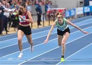18 February 2024; Claire Fagan of Mullingar Harriers AC, Westmeath, left, crosses the finish line to win the senior women's 3000m final as Niamh Kearney of Raheny Shamrock AC, Dublin, trips over during day two of the 123.ie National Senior Indoor Championships at the Sport Ireland National Indoor Arena in Dublin. Photo by Tyler Miller/Sportsfile
