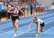 18 February 2024; Claire Fagan of Mullingar Harriers AC, Westmeath, left, crosses the finish line to win the senior women's 3000m final as Niamh Kearney of Raheny Shamrock AC, Dublin, trips over during day two of the 123.ie National Senior Indoor Championships at the Sport Ireland National Indoor Arena in Dublin. Photo by Tyler Miller/Sportsfile